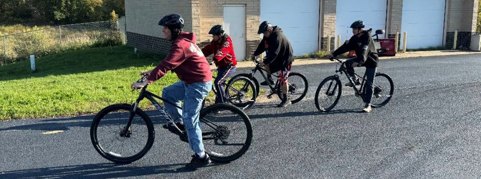 Students riding by on bicycles outside.