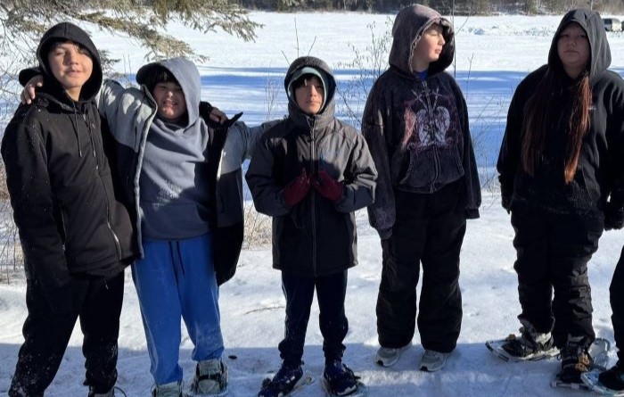 Students participating in ice fishing and snow shoeing at Circle of Life Academy.