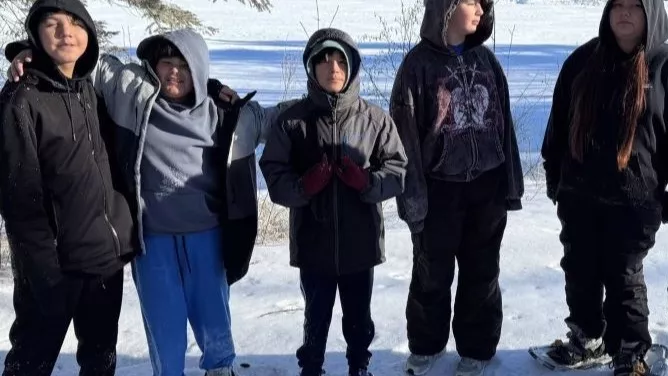 Students participating in ice fishing and snow shoeing at Circle of Life Academy.